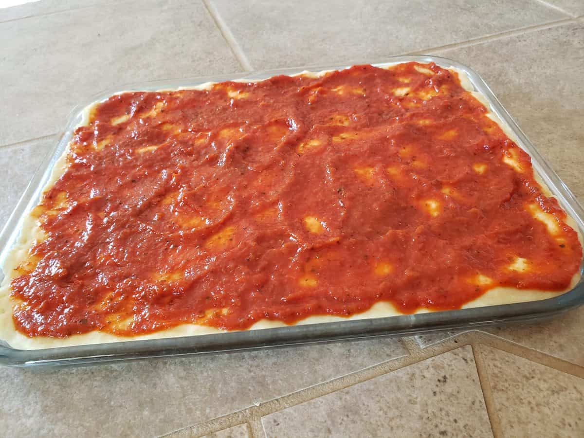 Spread the pizza sauce evenly on the pizza crust.