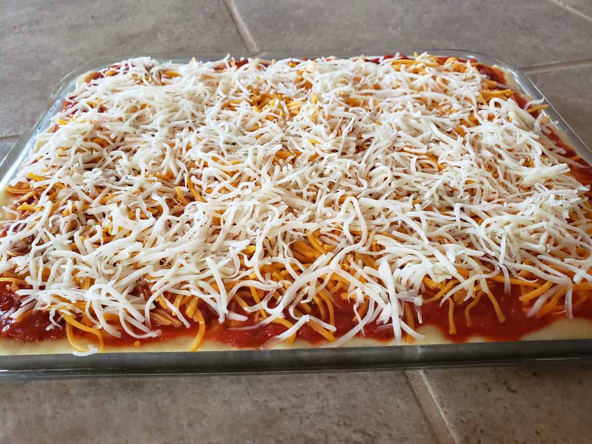 Add the mozzarella cheese on top of the cheddar cheese.