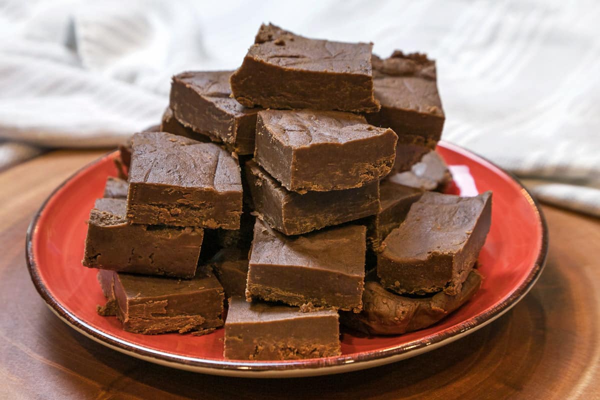 Peanut butter fudge cut into squares on a plate.