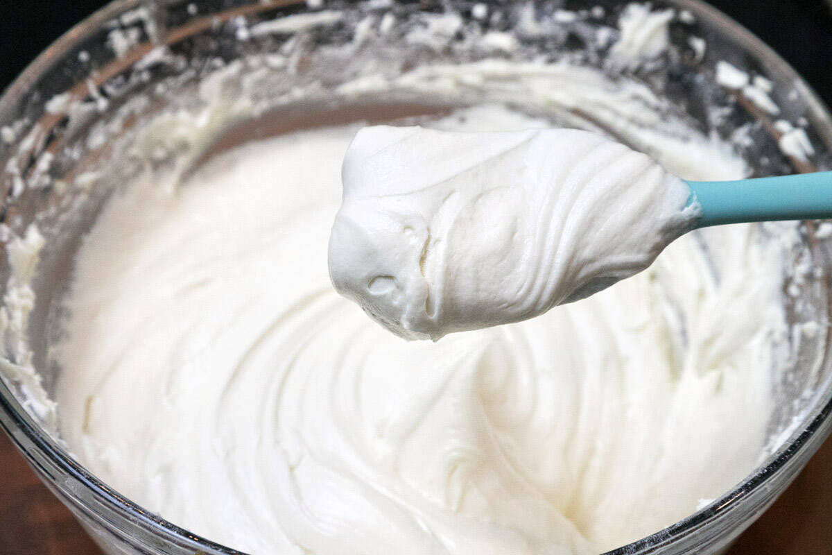 Thick and creamy white chocolate buttercream frosting in a bowl.