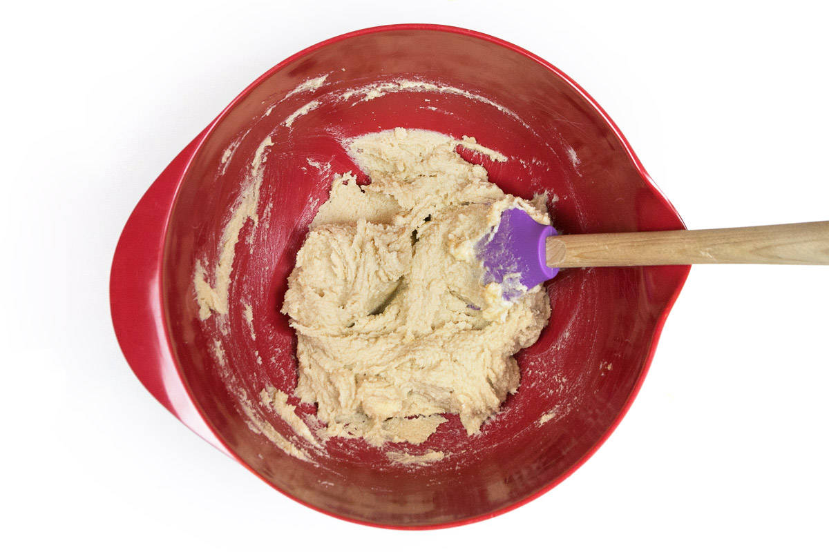 Softened butter, granulated sugar, and light brown sugar blened together in a bowl.