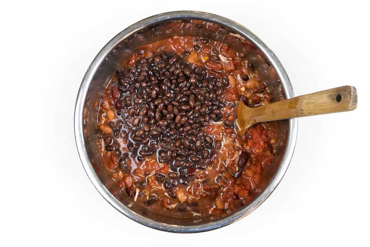 Add the cans of beans and tomatoes to the Instant Pot.