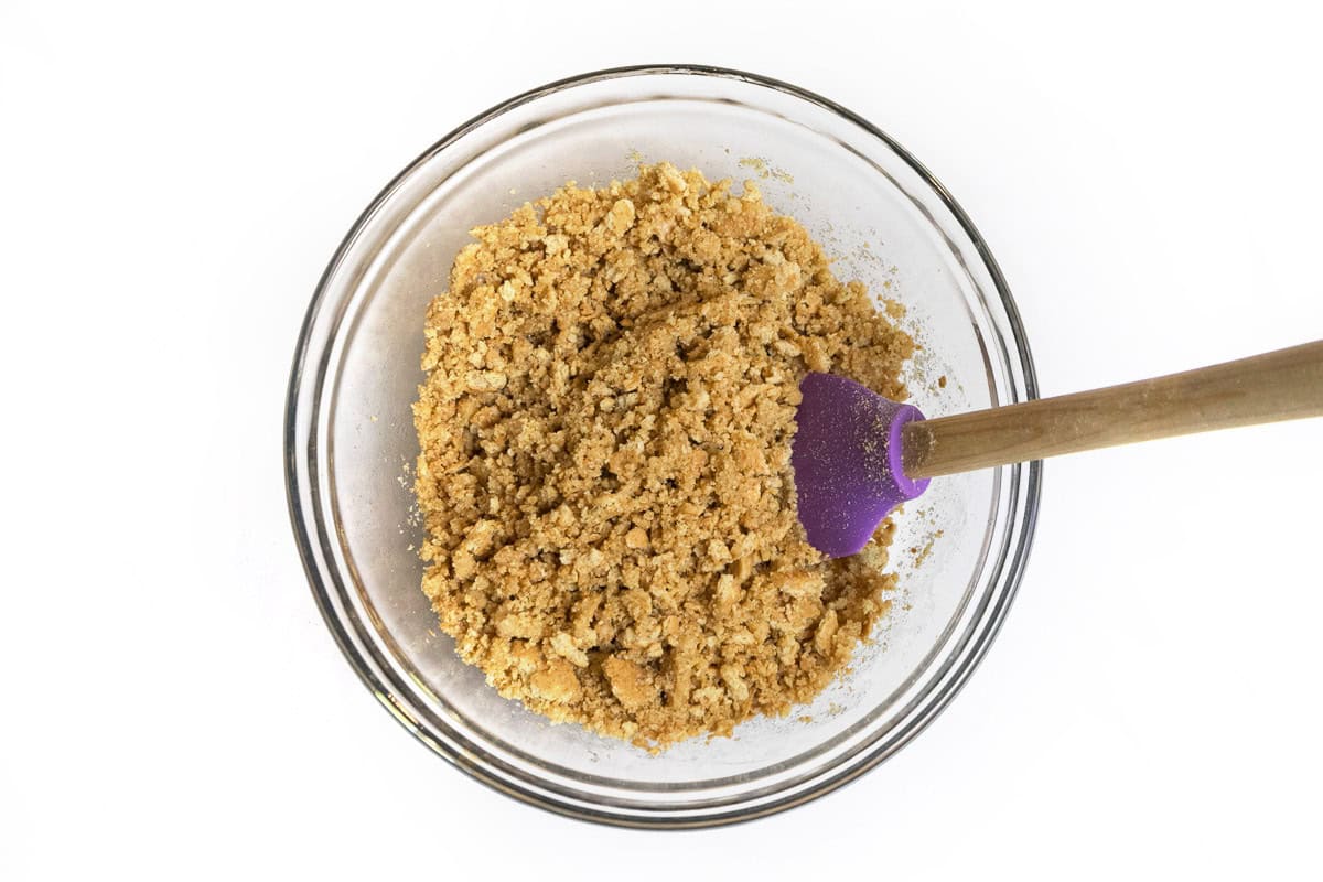 Crushed graham crackers, sugar, and melted butter in a bowl.