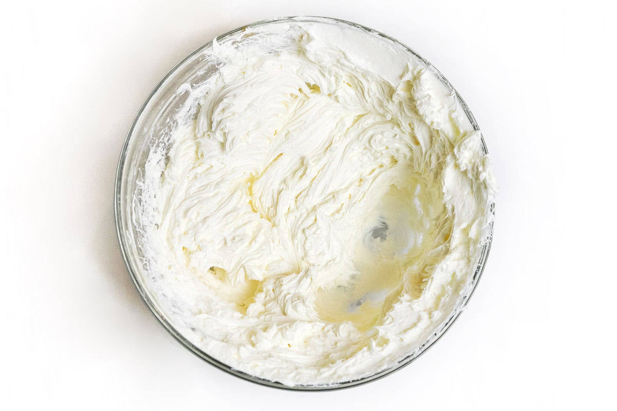 Beaten cream cheese in a bowl.