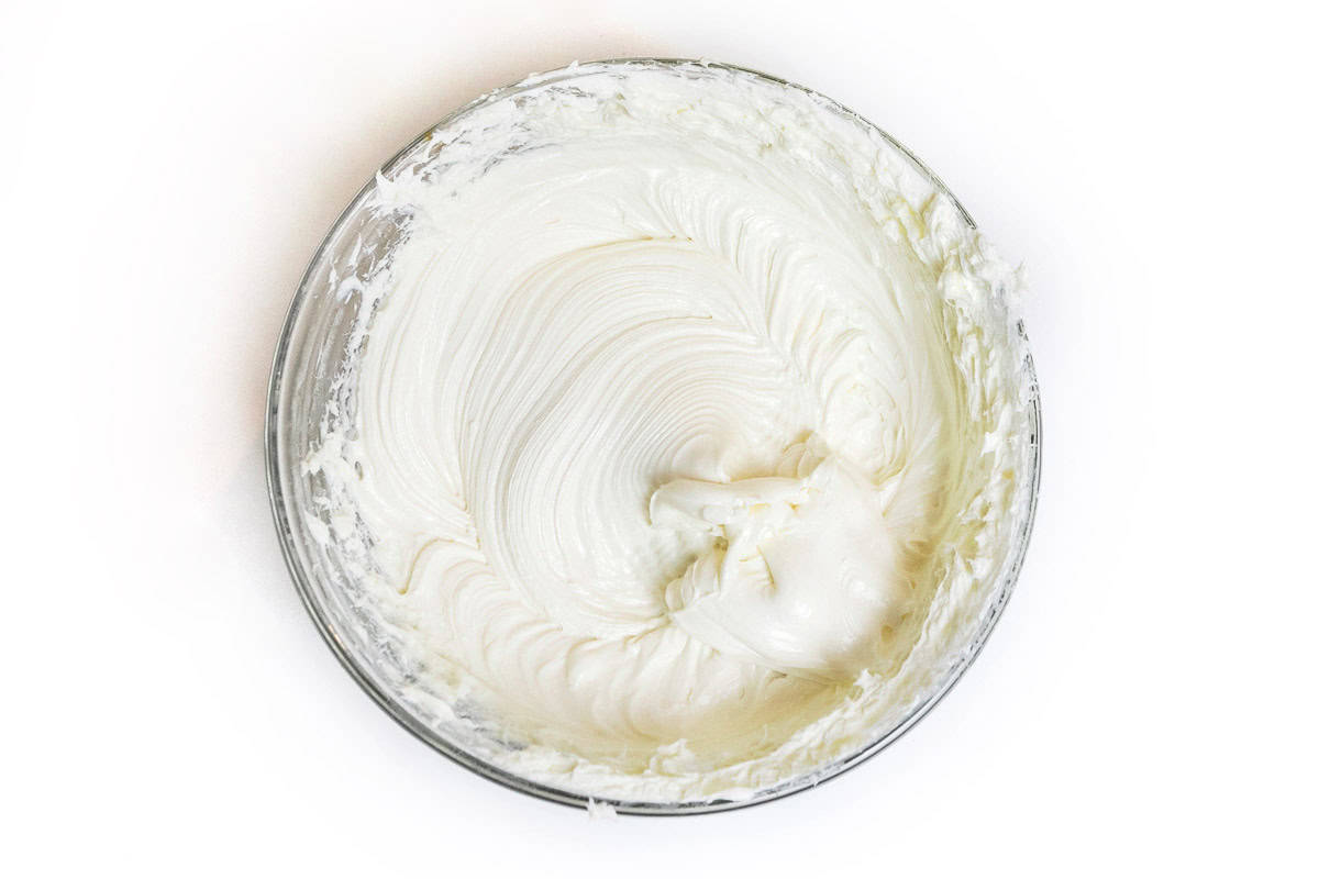 Beaten cream cheese in a bowl.