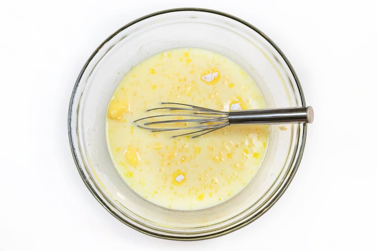 Milk and vanilla pudding mix in a bowl.