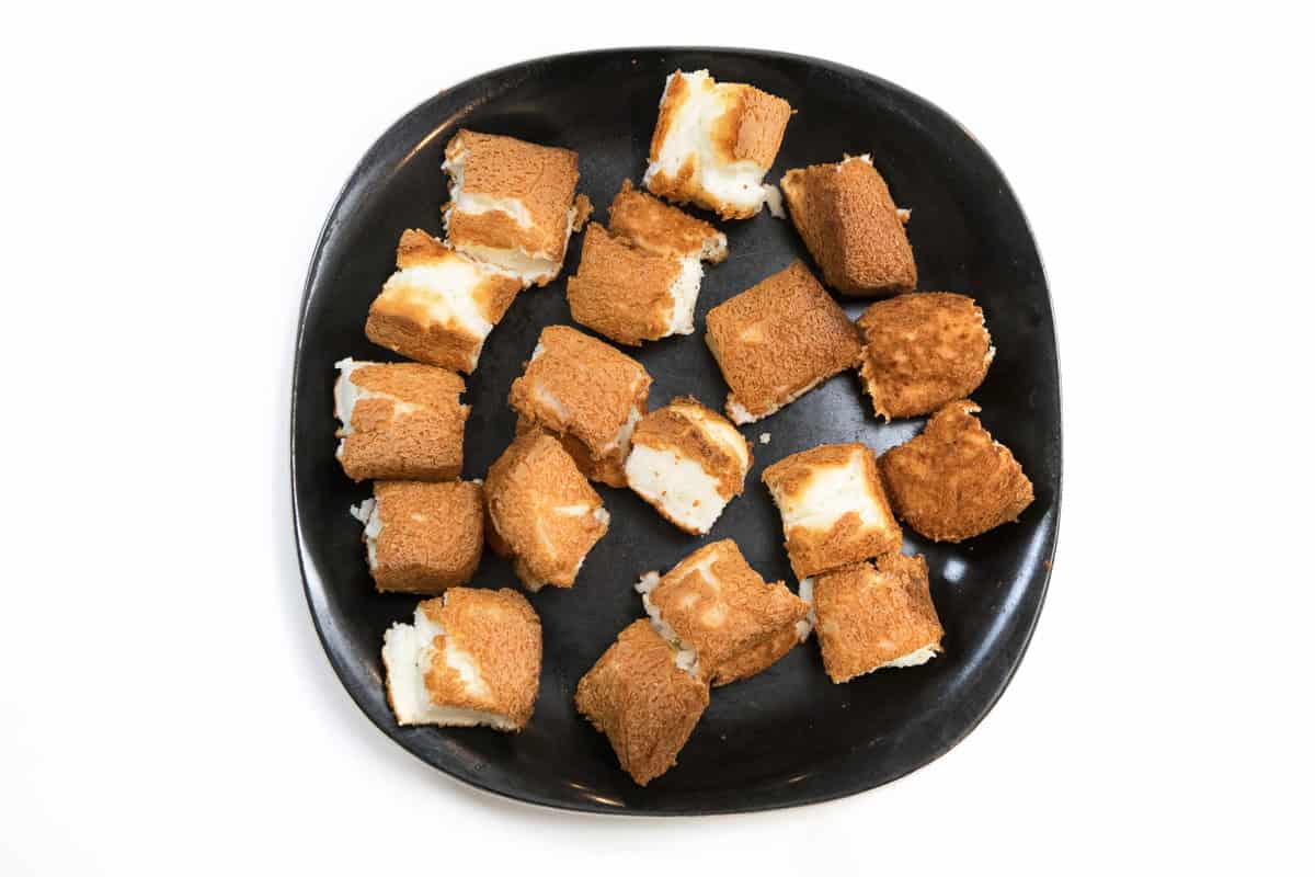 Angel food cake cut into cubes.