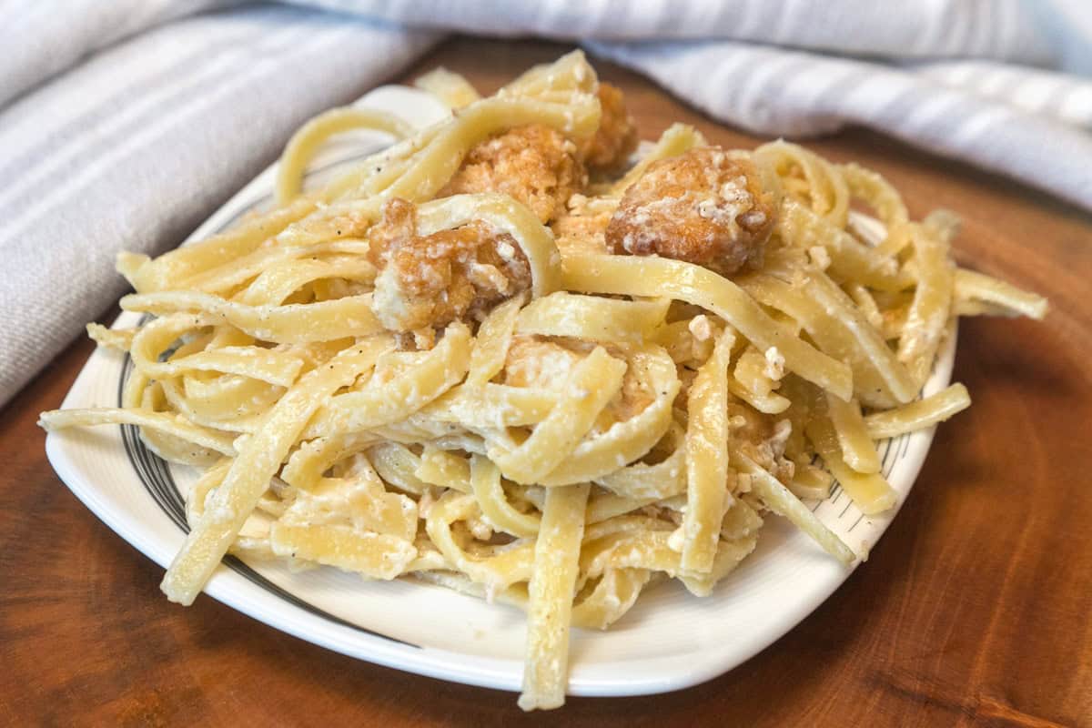 Crispy chicken fettuccine Alfredo on a plate.