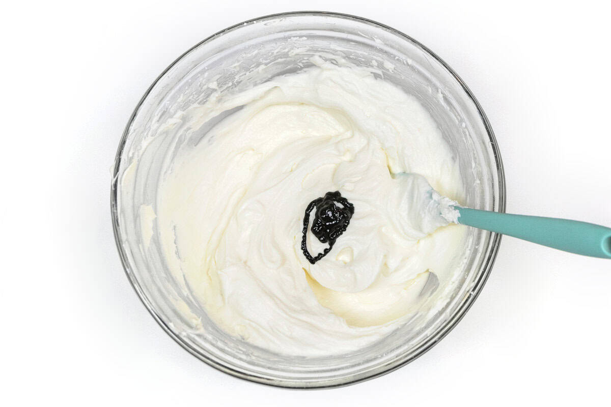 Green food coloring is added to the whipped cream and cream cheese mixture.