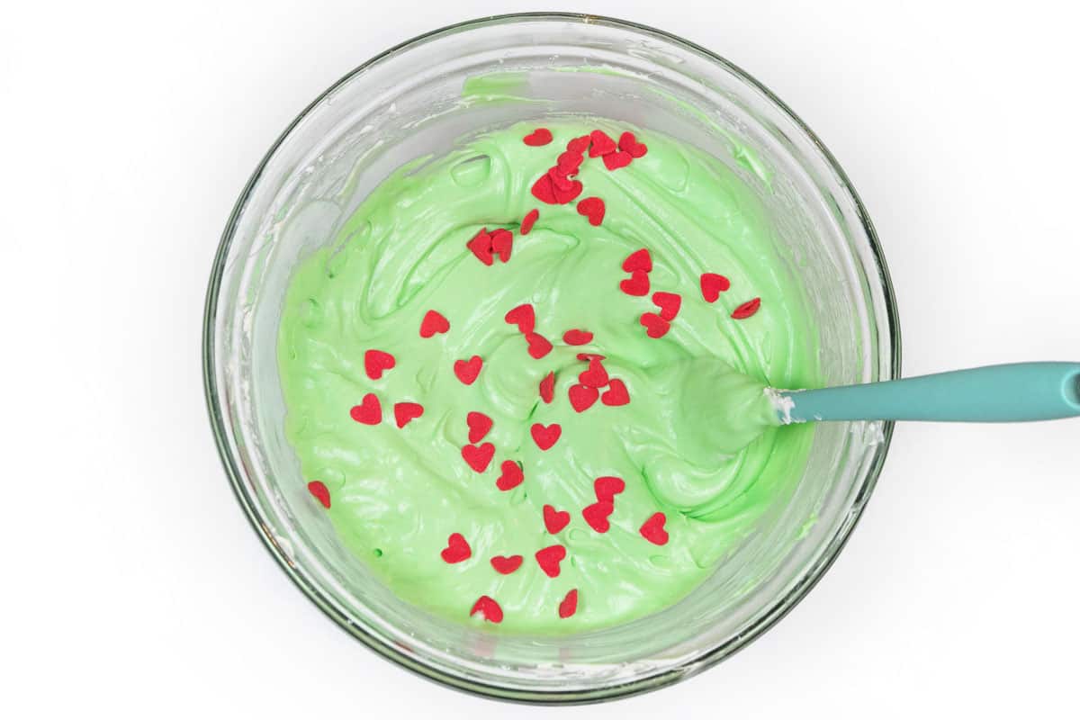 A few red heart sprinkles are added to the Grinch dip.