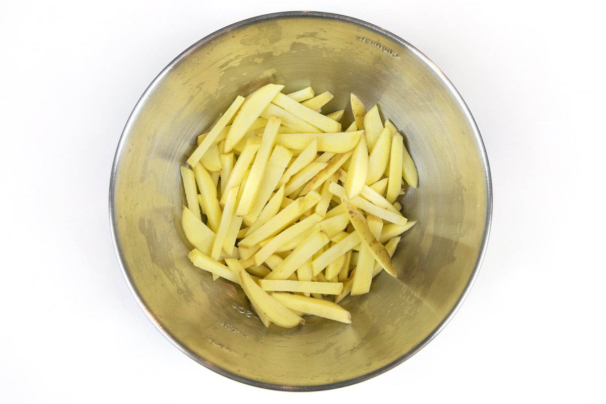 Sliced potatoes in a bowl.