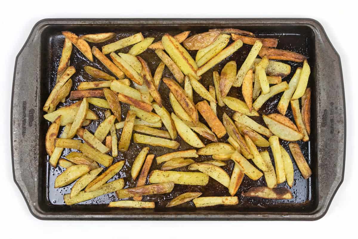 Baked French fries on a baking sheet.