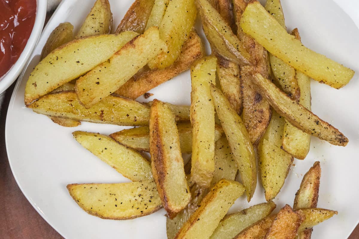 Crispy oven baked French fries on a plate.