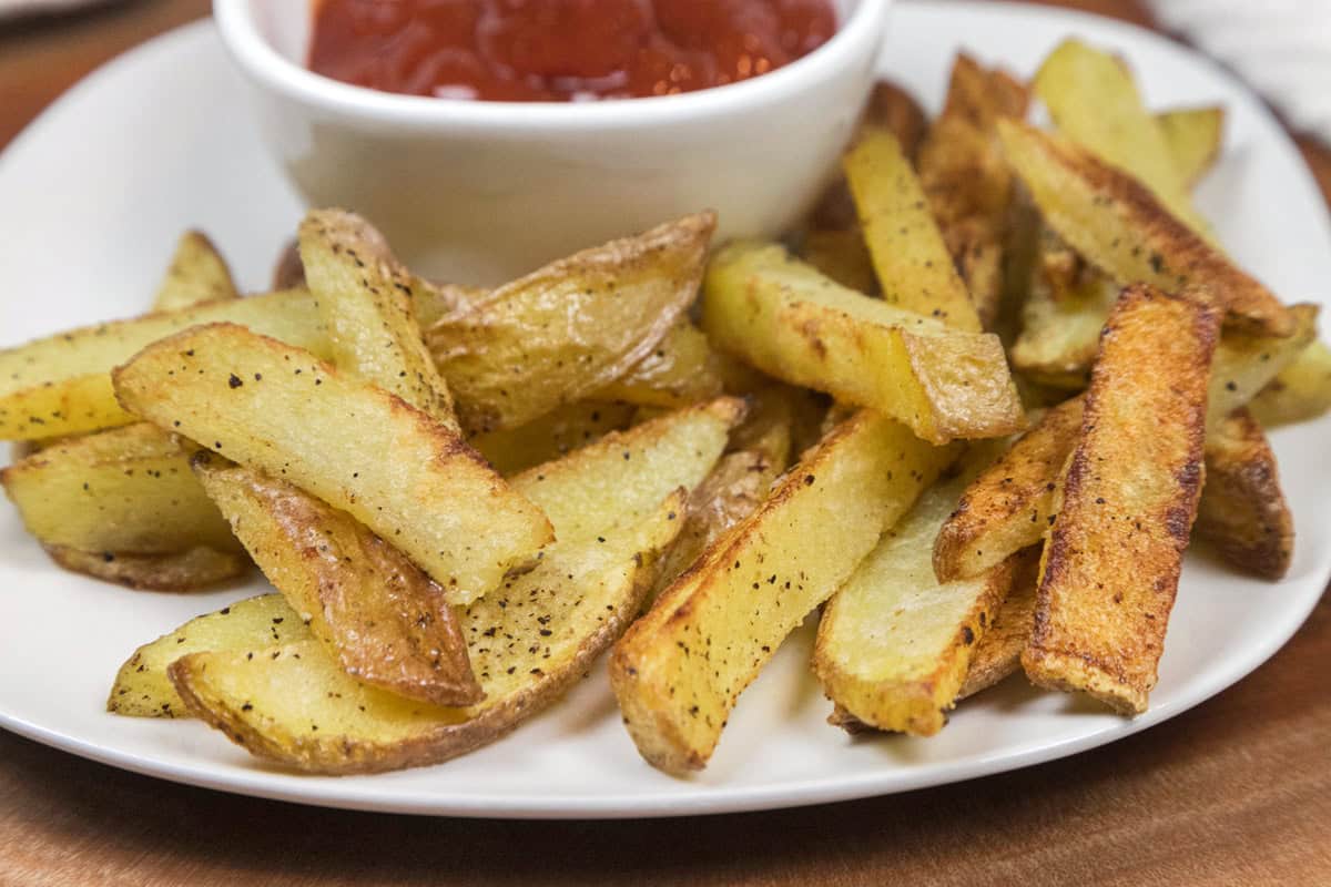 Crispy oven baked French fries on a plate.