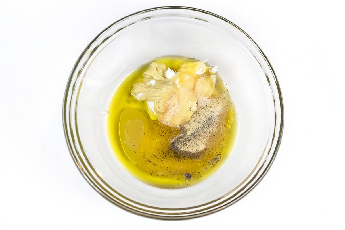 Ingredients for Greek yogurt honey mustard dressing in a bowl.
