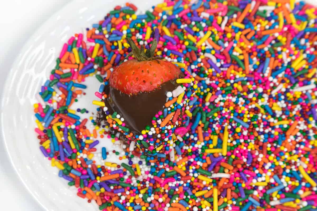Cover chocolate strawberries with sprinkles.