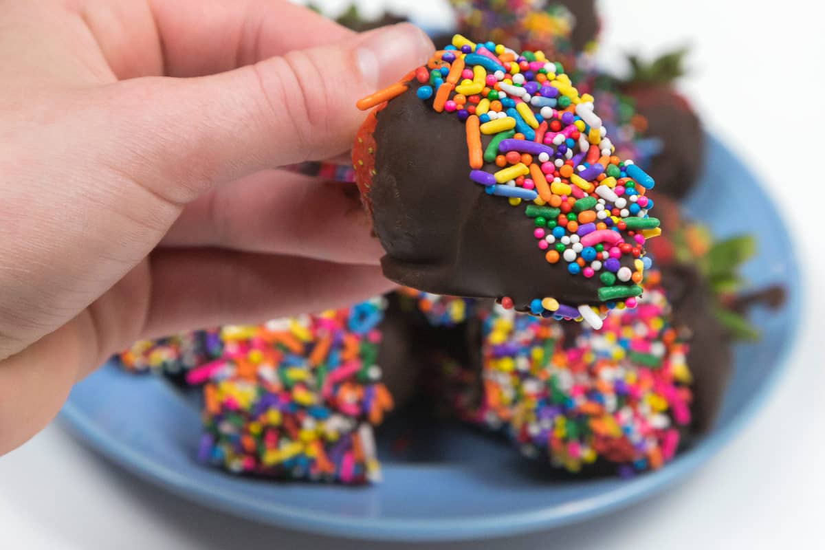 Chocolate covered strawberries with sprinkles.