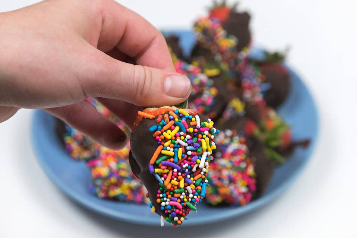 Chocolate covered strawberries with sprinkles.