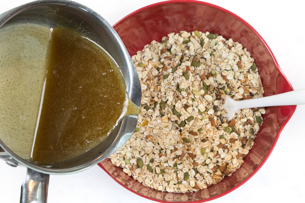Melted butter mixture is poured over the granola mixture.