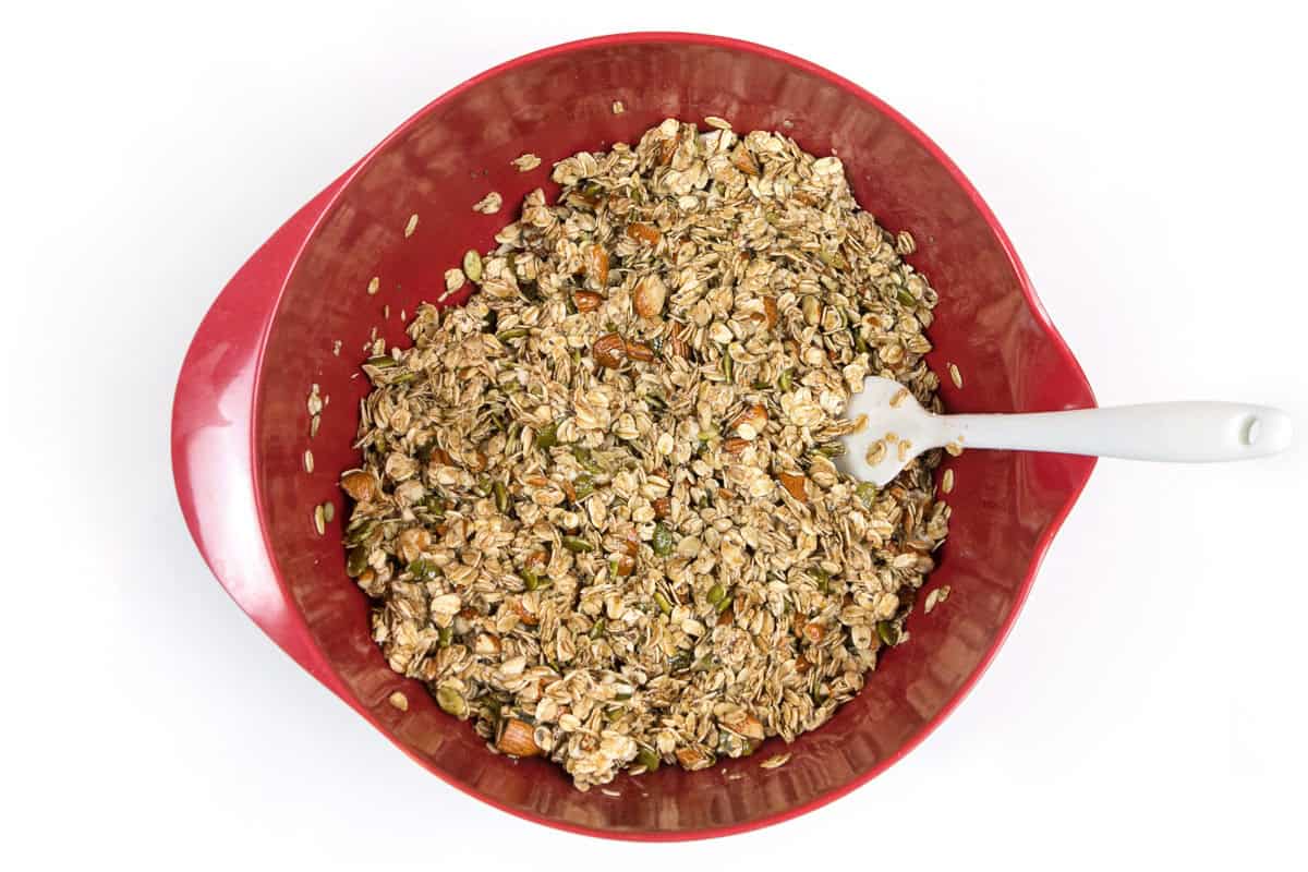 Almond granola with honey mixture in a bowl.