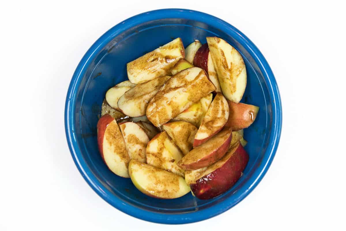 Cinnamon and melted butter are added together with the apple slices.