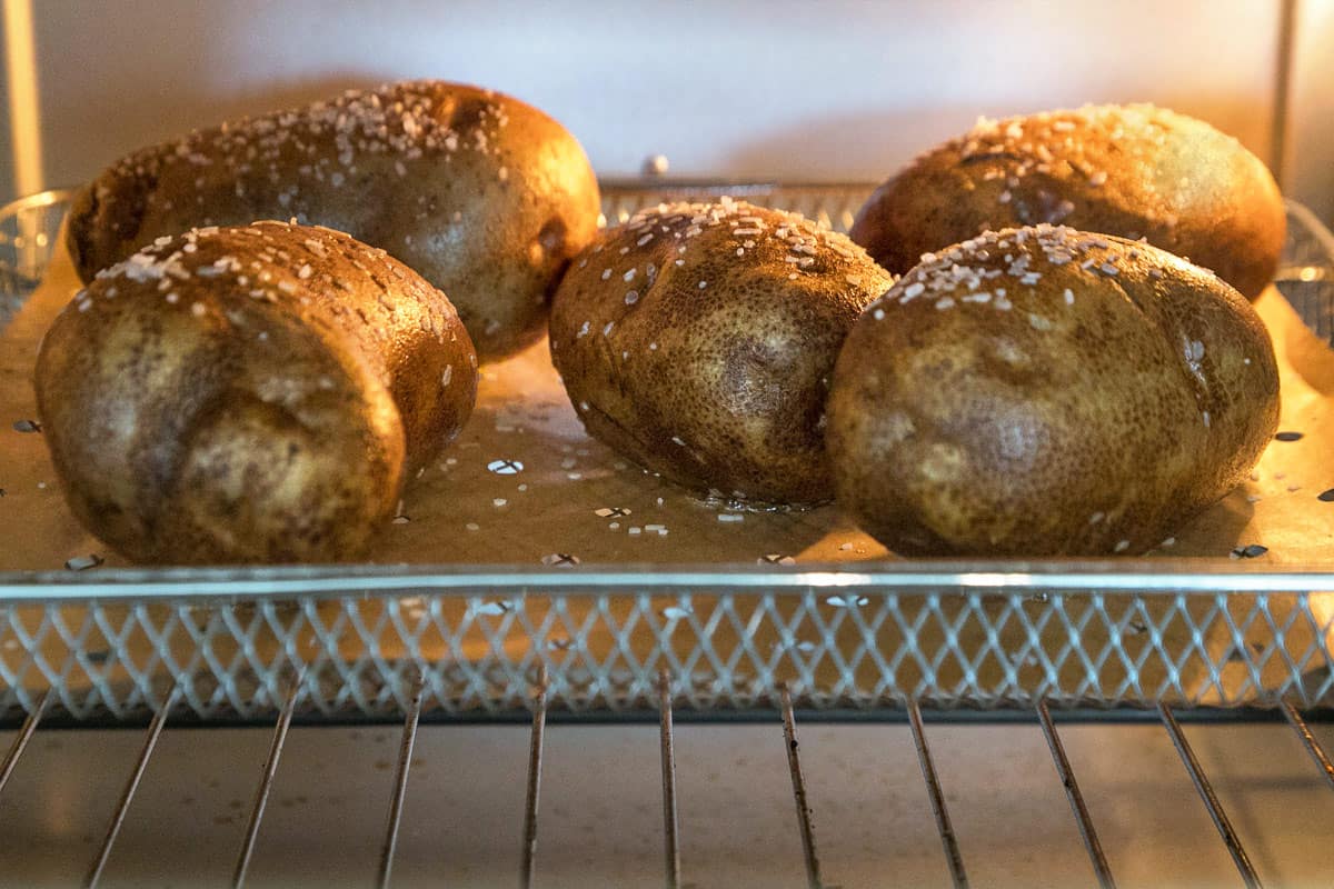 Bake the potatoes in the air fryer.