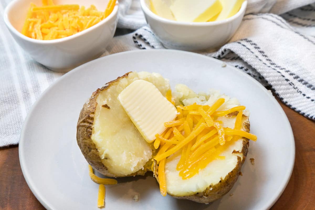 Air fryer baked potatoes on a plate.