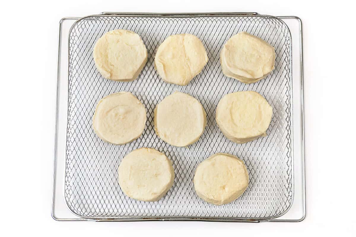 Lay out the canned biscuits on the air fryer tray.