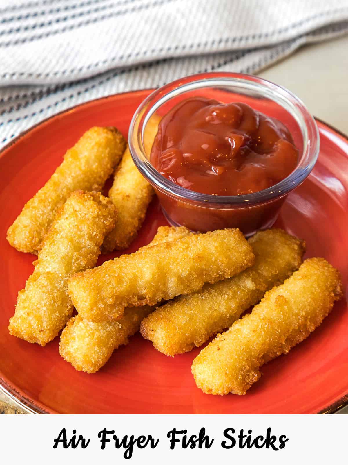 Air fryer fish sticks (frozen) on a plate.