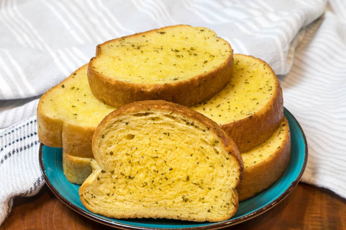 Slices of garlic bread on a plate.