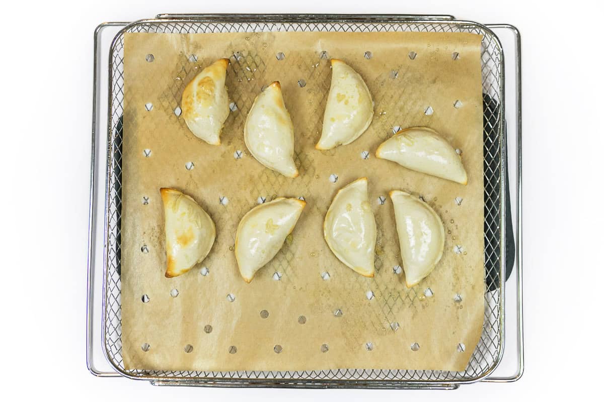 The potato and cheese pierogies are cooked in the air fryer at four hundred degrees Fahrenheit for twelve minutes.