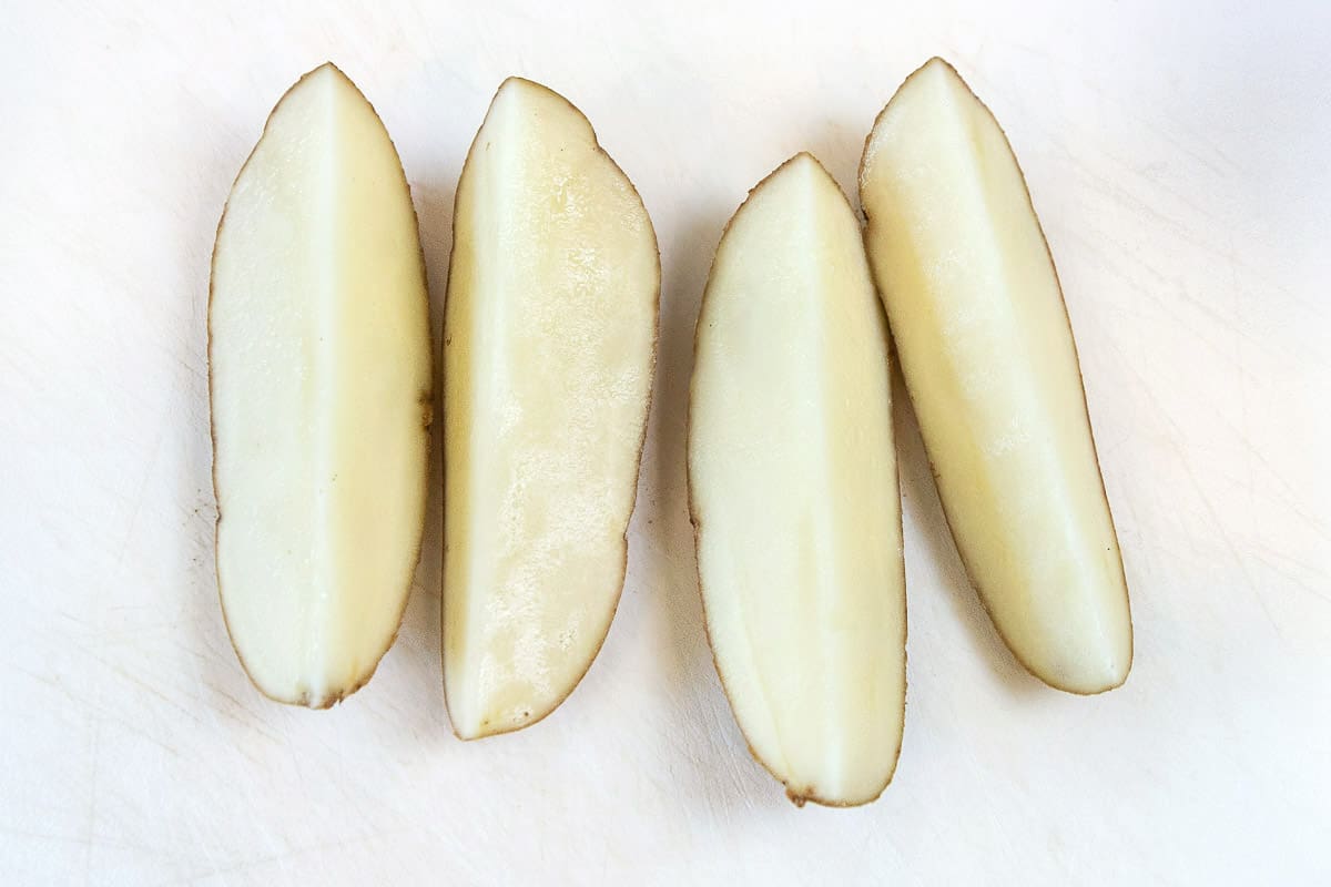 Cut the potato into fourths.