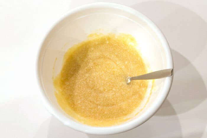 Applesauce is added to the shortening, sugar, and eggs.
