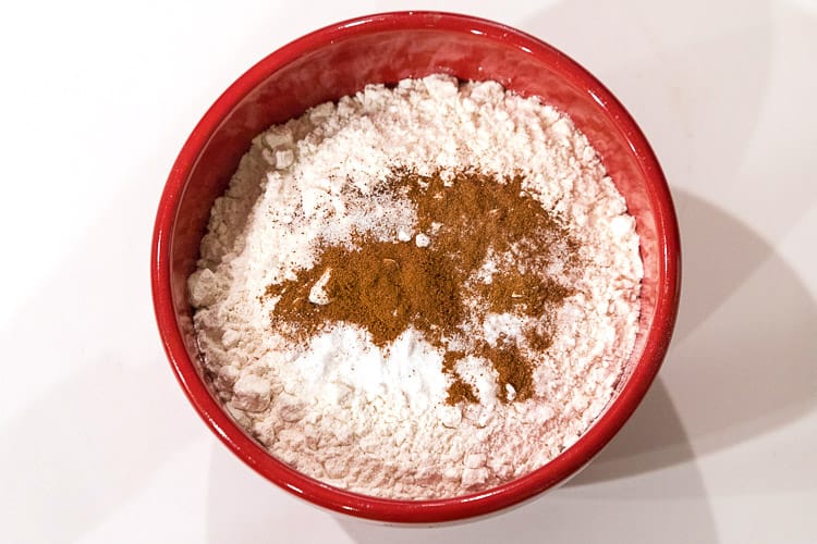 Flour, salt, cinnamon, cloves, and baking soda in a bowl.