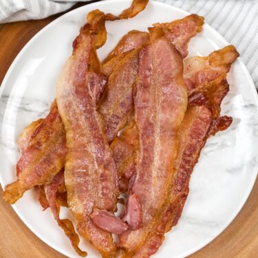 Air fried bacon on a plate.