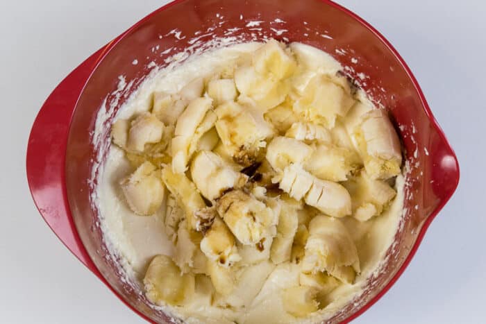 Vanilla extract has been added to the four bananas, eggs, melted butter, cream cheese, and sugar.