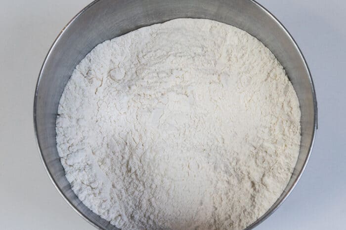Flour, salt, baking powder, and baking soda in a bowl.