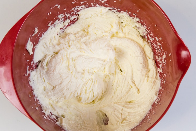 The butter, cream cheese, and sugar are mixed together with an electric hand mixer until fluffy.