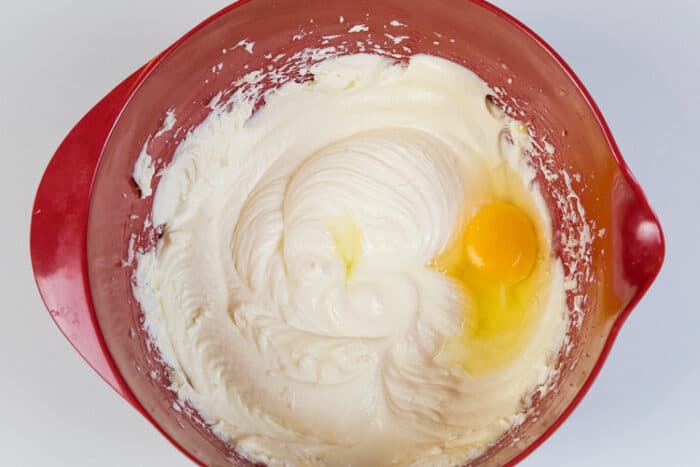 Another egg has been added to the melted butter, cream cheese, and sugar.