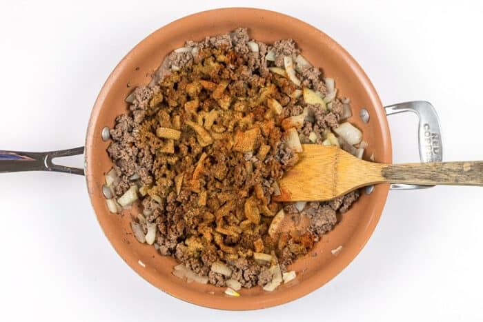Add the cumin, cayenne pepper, and paprika to the ground beef mixture.