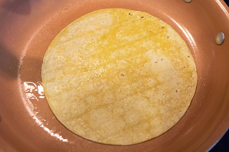 One tablespoon of olive oil in the frying pan on medium heat and fry a tortilla for 15 seconds on each side.