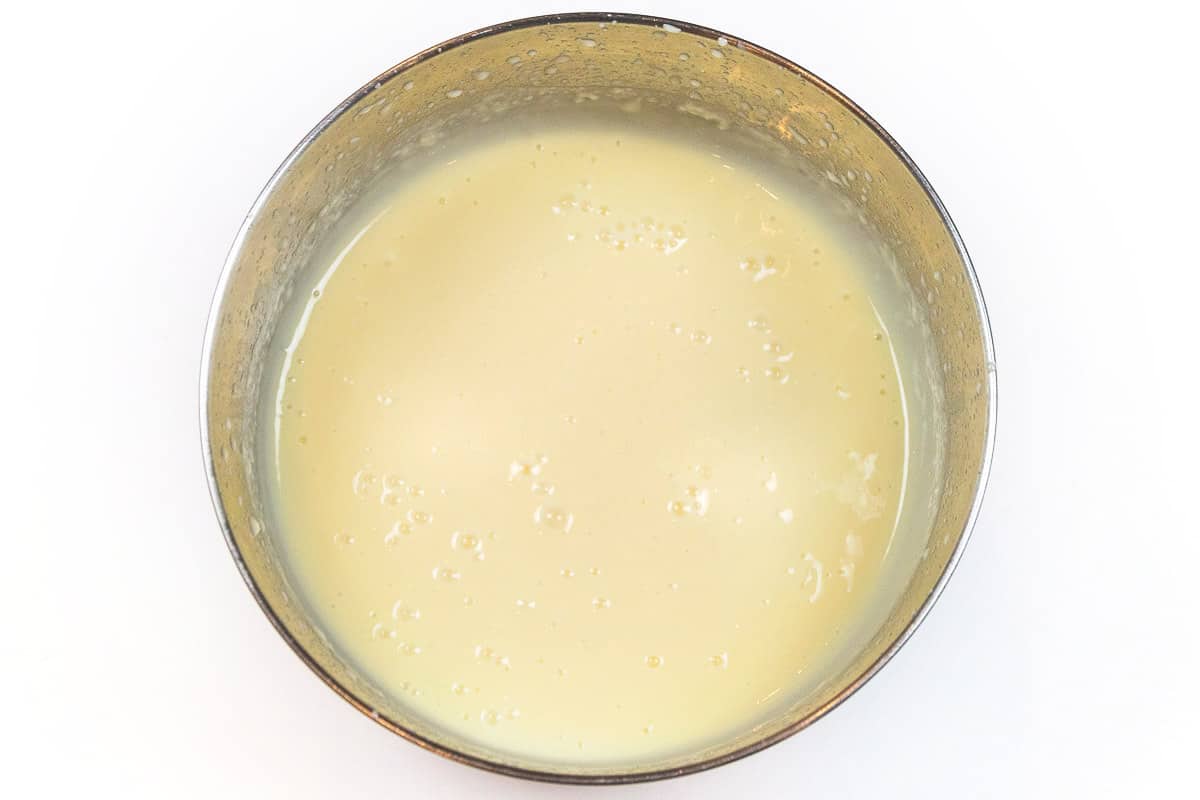  The cheesecake instant pudding is mixed with the milk using an electric mixer.