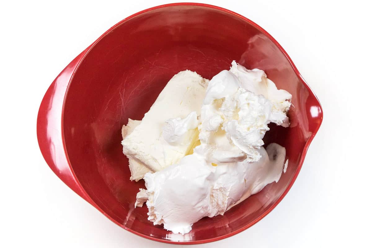  The cream cheese is added to the two cups of whipped topping. 