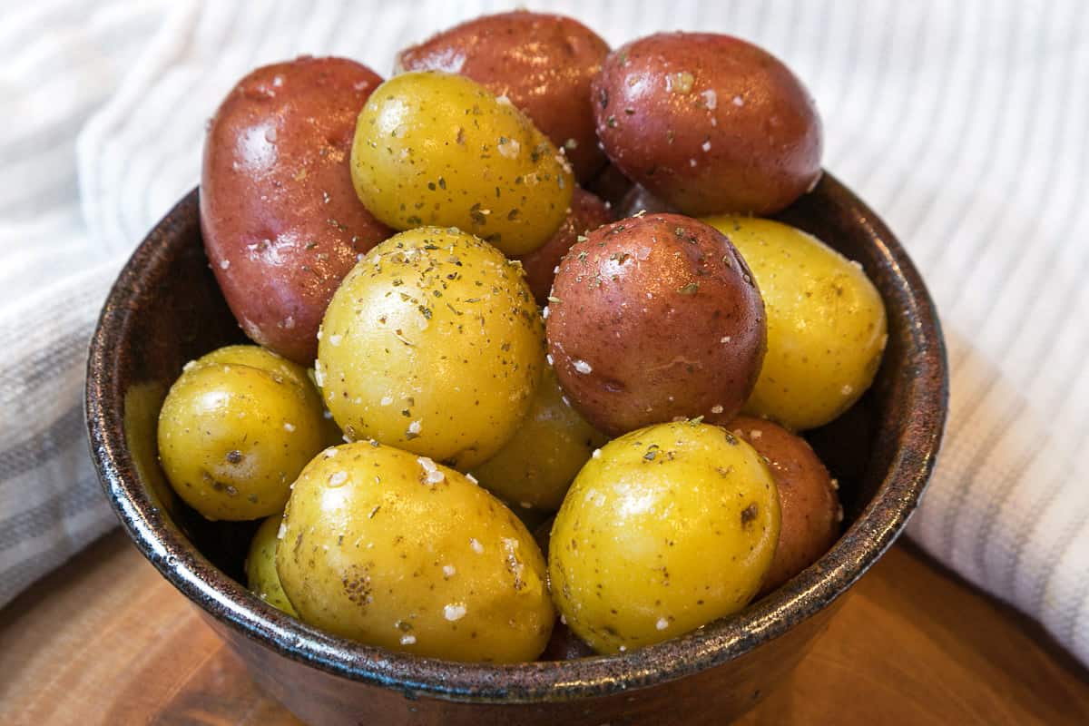 A bowl of cooked baby potatoes.