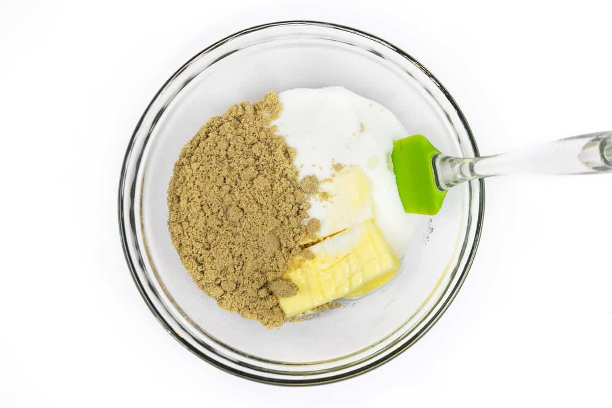 Softened butter, granulated sugar, and light brown sugar are added to a bowl.