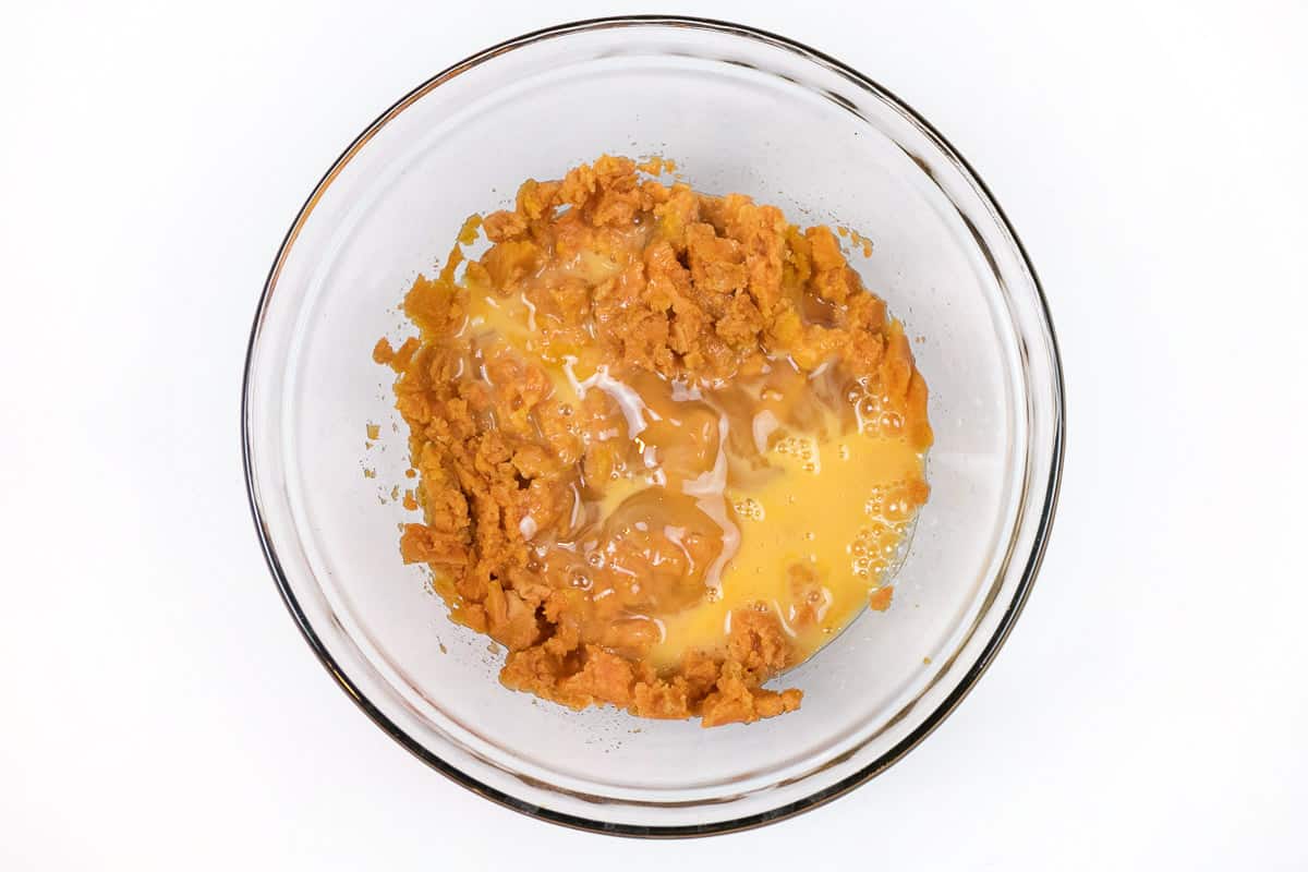 The beaten eggs are added to the mashed sweet potatoes.