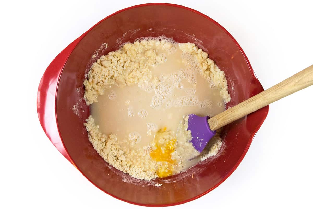 The yeast mixture and one egg are immediately added to the crumbly mixture.