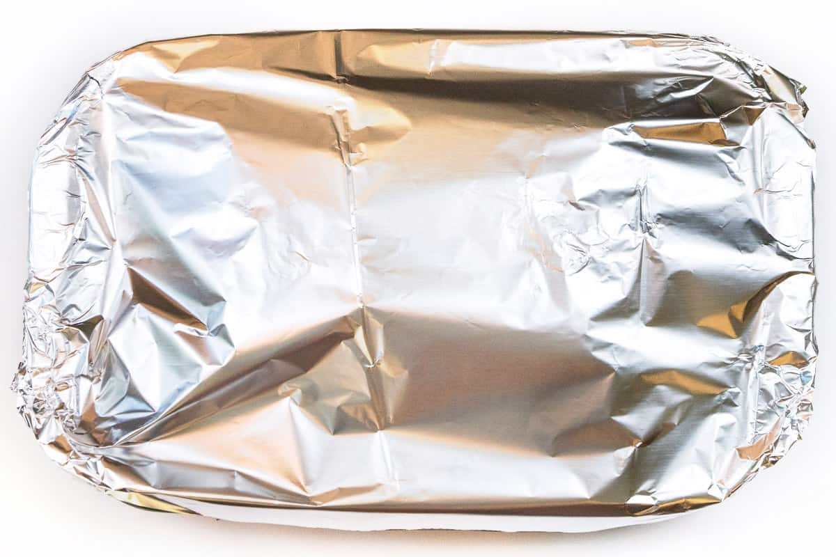Cover the baking dish with aluminum foil. Bake at three hundred and seventy-five degrees Fahrenheit for thirty minutes. Then remove the aluminum foil and bake for another fifteen minutes until the cheese is lightly browned.