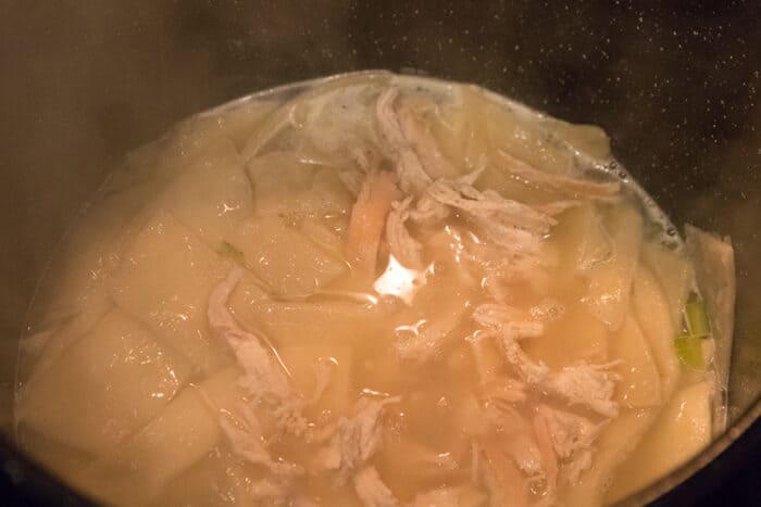 Chicken and broth added to the pot of dumplings.