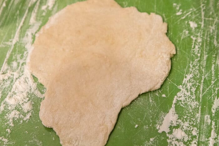 Flour dough flattened with rolling pin.